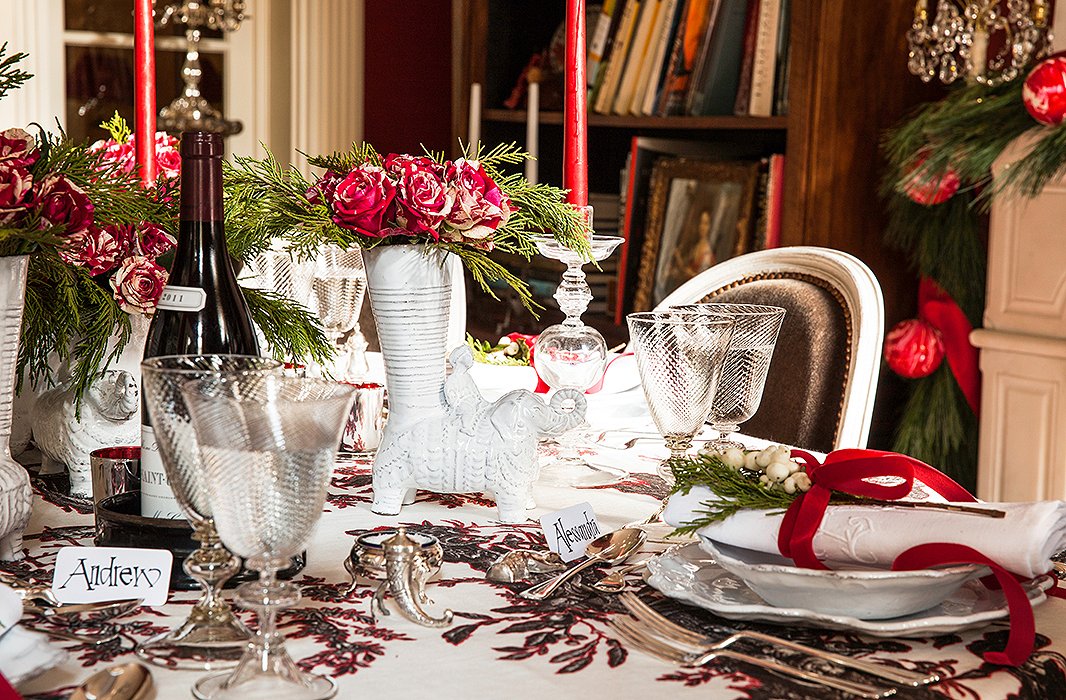 Astier de Villatte elephant vases are grouped together for a whimsical centerpiece on the table, which is covered in an embroidered toile Alessandra designed for Schumacher. She also designed the handblown Belgian glassware.
