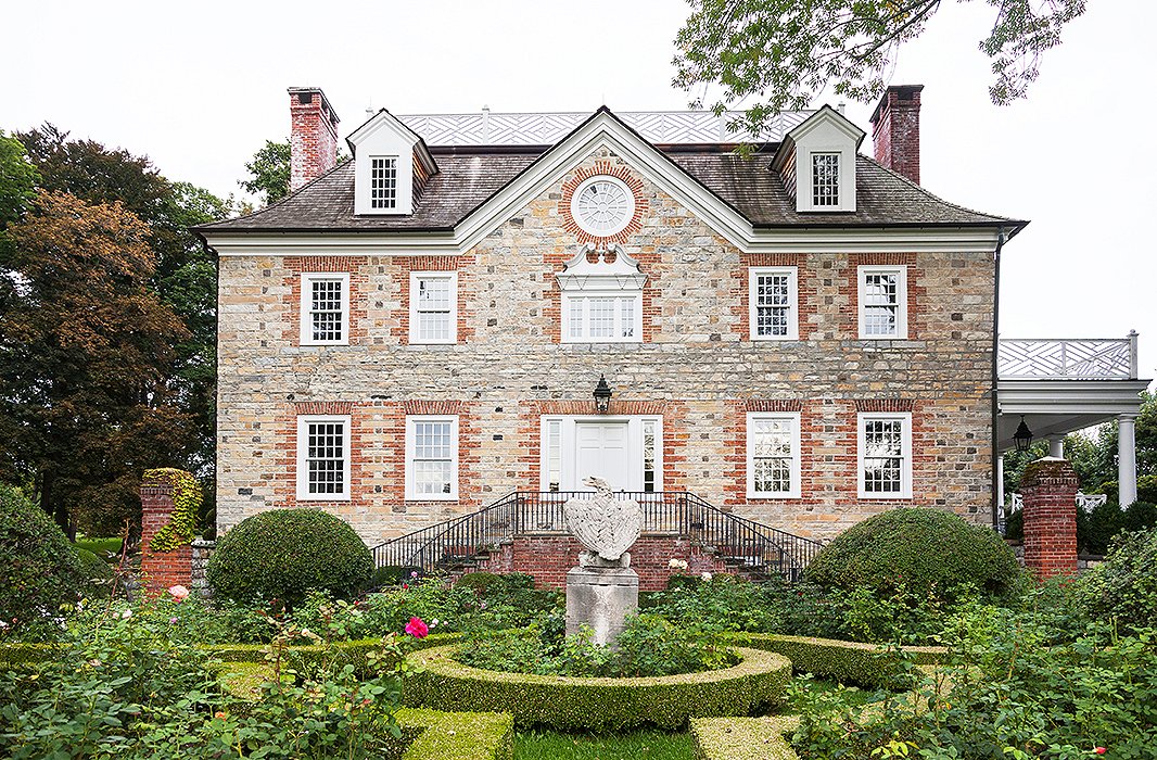 A view looking over the rose garden—which Carolyne calls in At Home in the Garden “a formal garden, but a happy one.” Korean boxwood, which survives New England winters well, frames the roses.
