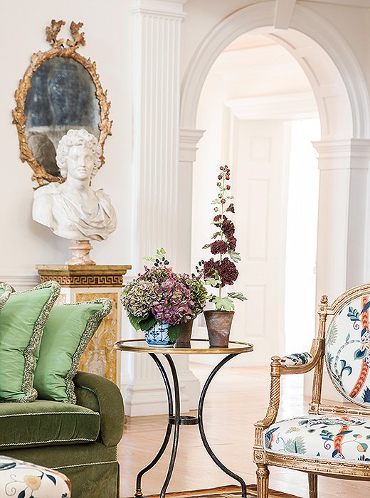 Each room features a different tone of white on the walls, achieved by mixing up to four paints. Here, the white sets off the classical elements of a pilaster next to a gentle arch.
