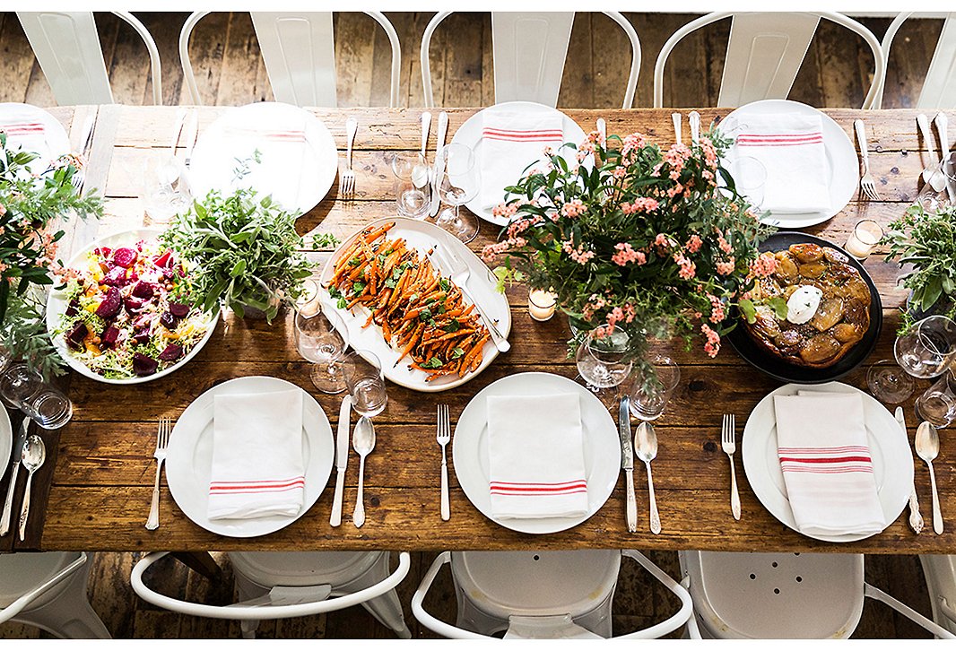 Classic white plates, striped linens, and unfussy floral arrangements prove simple can be just as special as over-the-top. Photo by Lesley Unruh.
