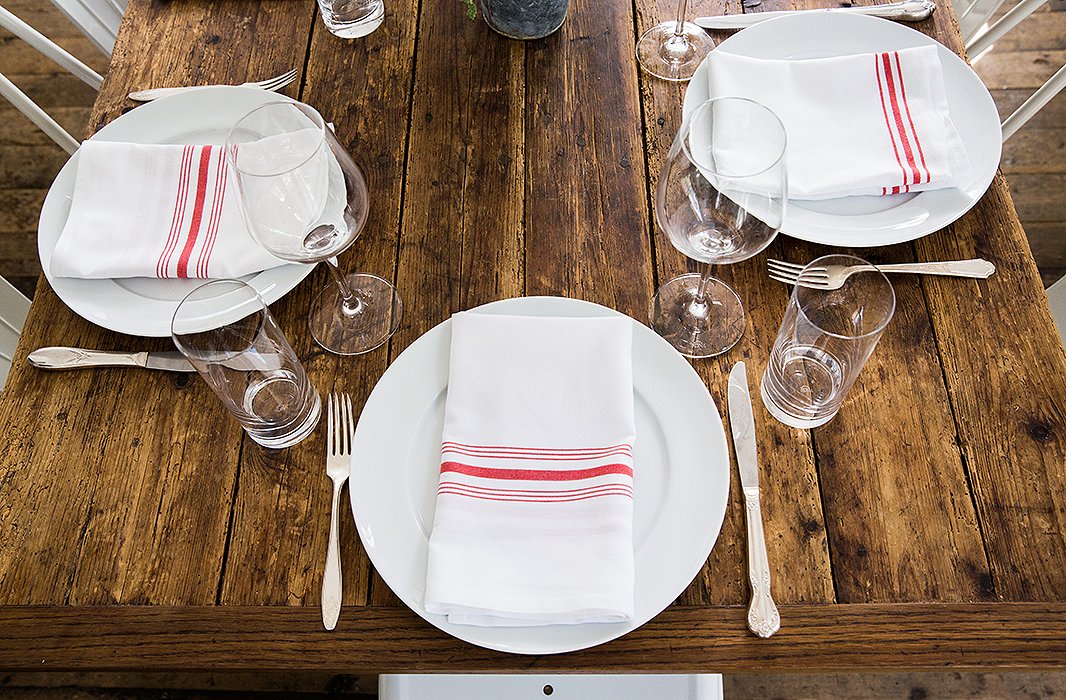 No need for a tablecloth, unless there’s one you adore using—raw wood looks beautiful and sets off food perfectly.
