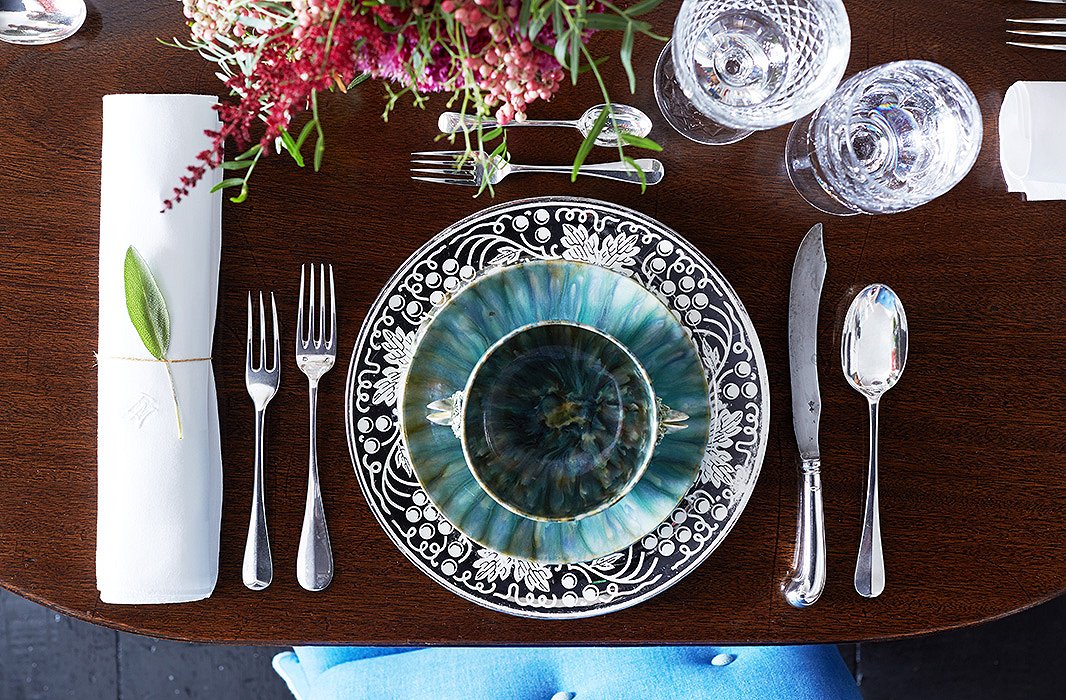 In lieu of a fanciful tablecloth, Jeffrey lays out American platinum-leaf lusterware chargers and English pottery plates and bowls for the ideal touch of pattern and texture.
