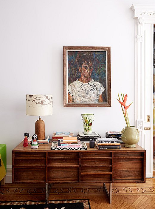 A pair of South African dolls, saved from the Harlem school that Jodie’s mother ran, sit on the credenza along with beloved art and design books.
 
 
