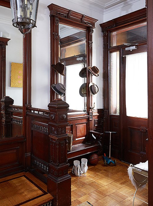 The entryway now houses scooters and a fedora collection, but it has vestiges of the past century—like a copper intercom system.
