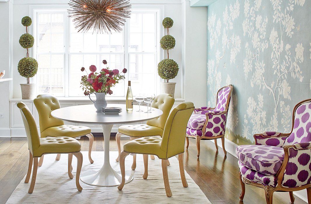 One of the children drew another flower onto the Gracie wallpaper, but otherwise everything—the Tulip table, the chairs, the rug—can be easily wiped down or washed.
