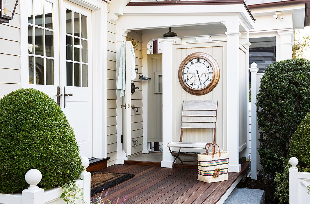 A painted outdoor shower area leads the eye from the home’s pool into the rest of the house.
