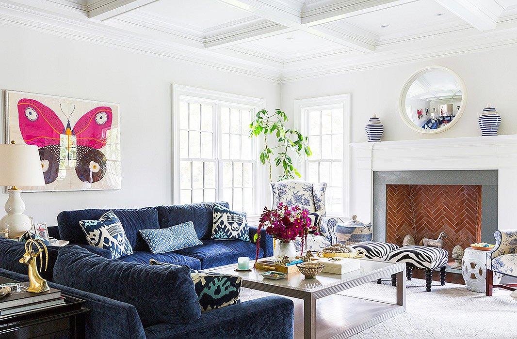 The foundation of the family room is relaxed—note those cushy chenille sofas—but Sue made the atmosphere higher-octane and more fun with pieces like a Natural Curiosities butterfly artwork, a lidded African basket, and a set of zebra stools.
