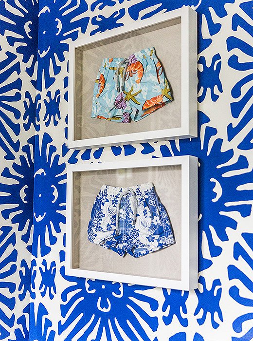 Sue loves to frame anything precious. Case in point? These swim trunks—which her son outgrew—now hang in the wallpapered powder room. When framing scarves, dresses, or other apparel, she suggests having them pressed by a dry cleaner first, and then having a professional framer transfer them to canvas.
