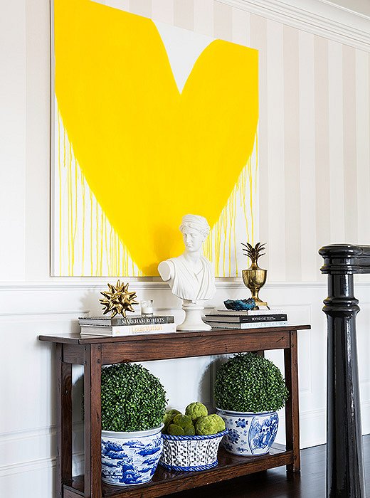 At the landing at the top of the stairs, a picture of a giant heart provides a clever contrast to the otherwise traditional decor.
