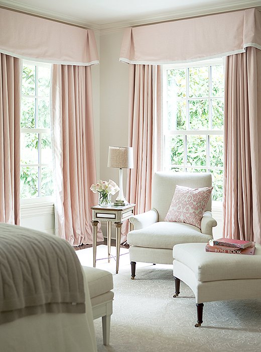What guest wouldn’t want to curl up in this sunny corner? Swathed in white and shell pink, the room is a dreamy confection.
