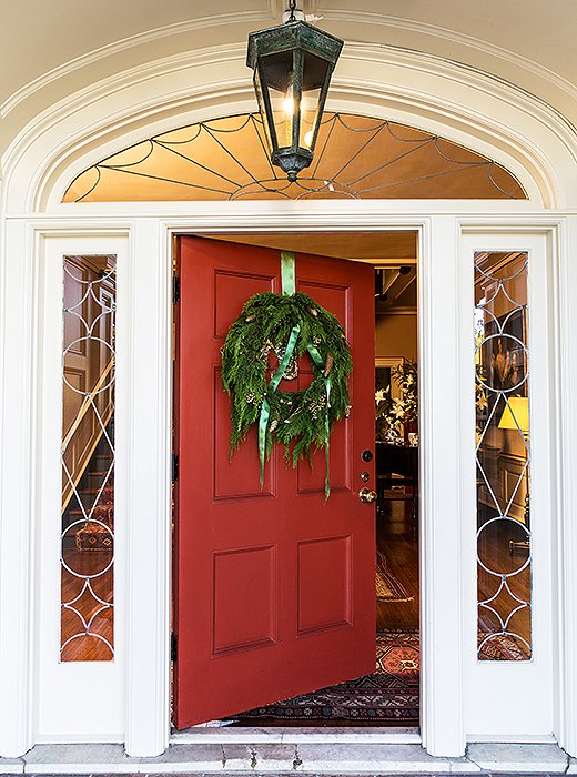 A simple boxwood-and-pinecone wreath works especially well with traditional architecture. Leaving the bow untied adds a bit of tossed-off glamour.
