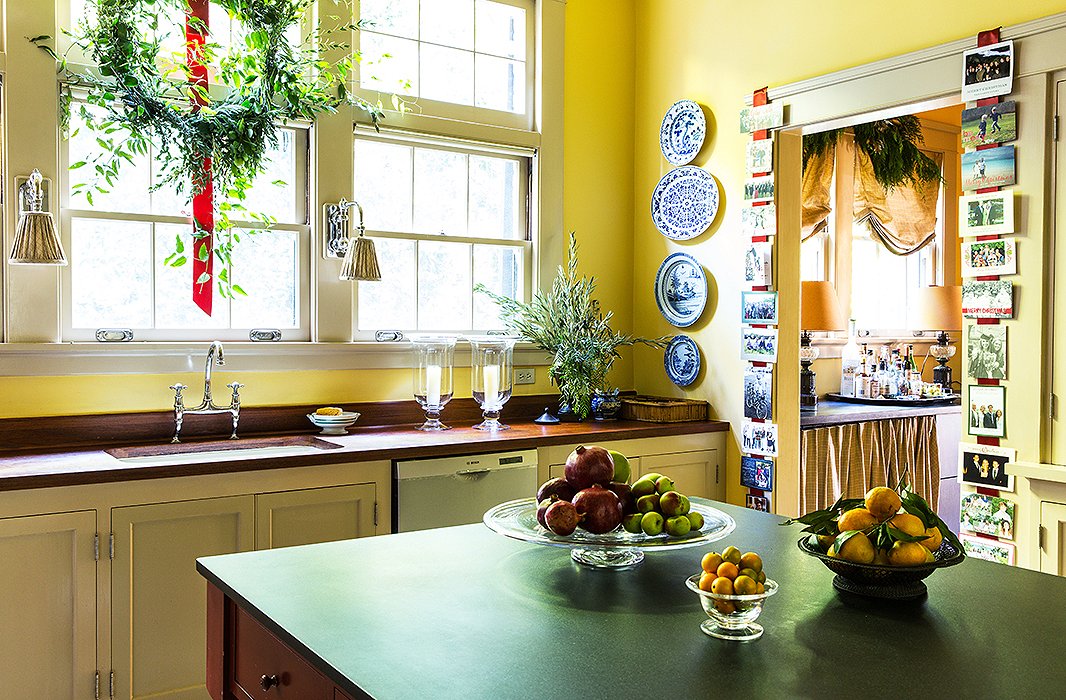 The holiday spirit carries through to the kitchen, where Rheinstein strings all the Christmas cards with family pictures she’s received on a ribbon that runs down both sides of the door.
