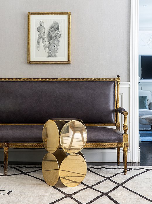 Gold finishes, ranging from polished to beautifully tarnished, act as a unifier that makes this seating area shine.
