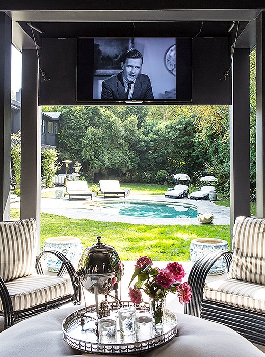 Indoor luxuries big and small—a drop-down movie screen, a silver tray topped with fresh-cut blooms—make the pool pavilion especially comfortable and welcoming.
