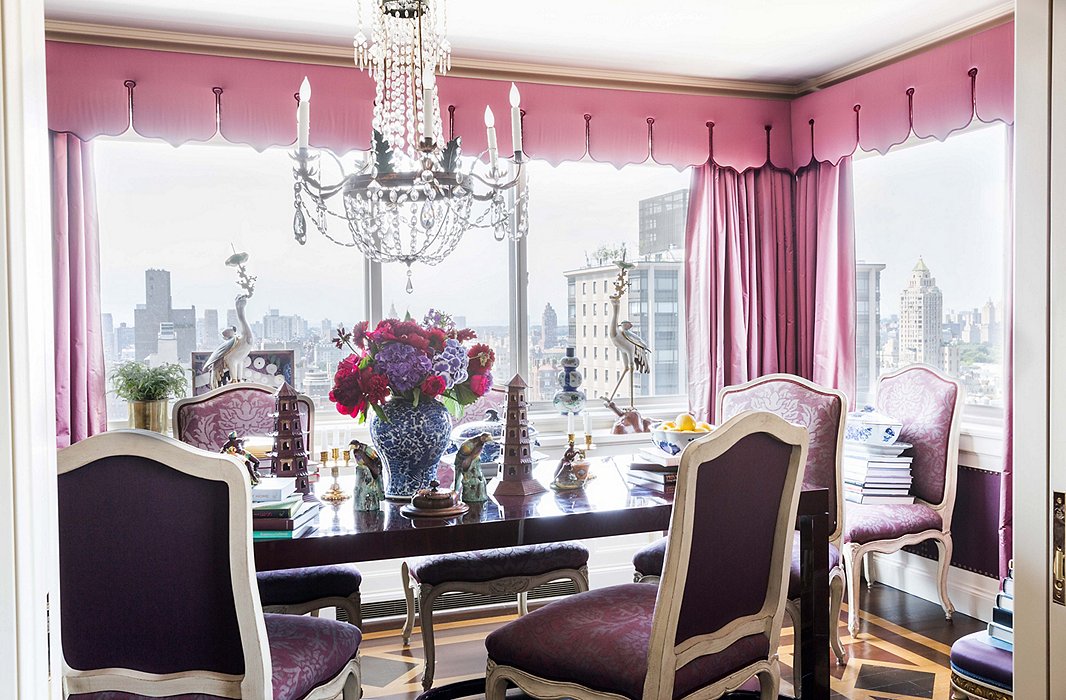 An array of purple hues turns the dining room into a jewel box. The living and dining room floors feature complementary parquet patterning, each created with a stencil. Shop an array of crystal chandeliers here.
