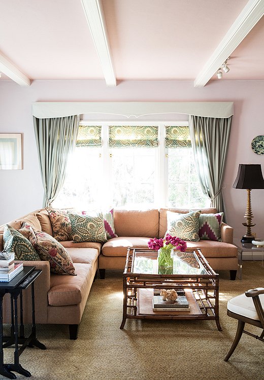 In Chloe’s den, a Barbara Barry for Henredon sectional topped with custom pillows is backed by walls painted Philip’s Perfect Colors’ Dusk. Pink is one of the sweetly traditional shades that makes an appearance in many a Chloe project.
