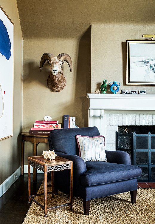 Chloe has a thing for what she calls “paper-bag browns.” Painted Philip’s Perfect Colors’ Mink, her living room walls provide a warm but neutral backdrop to classic furniture pieces like this armchair in custom black linen from Barclay Butera Home.
