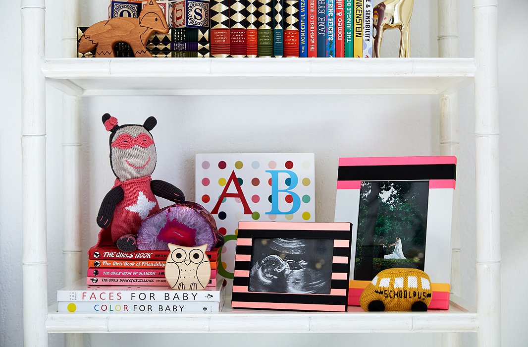 The shelves feature treasured photographs, such as an ultrasound image and a shot of the couple from their wedding day.
