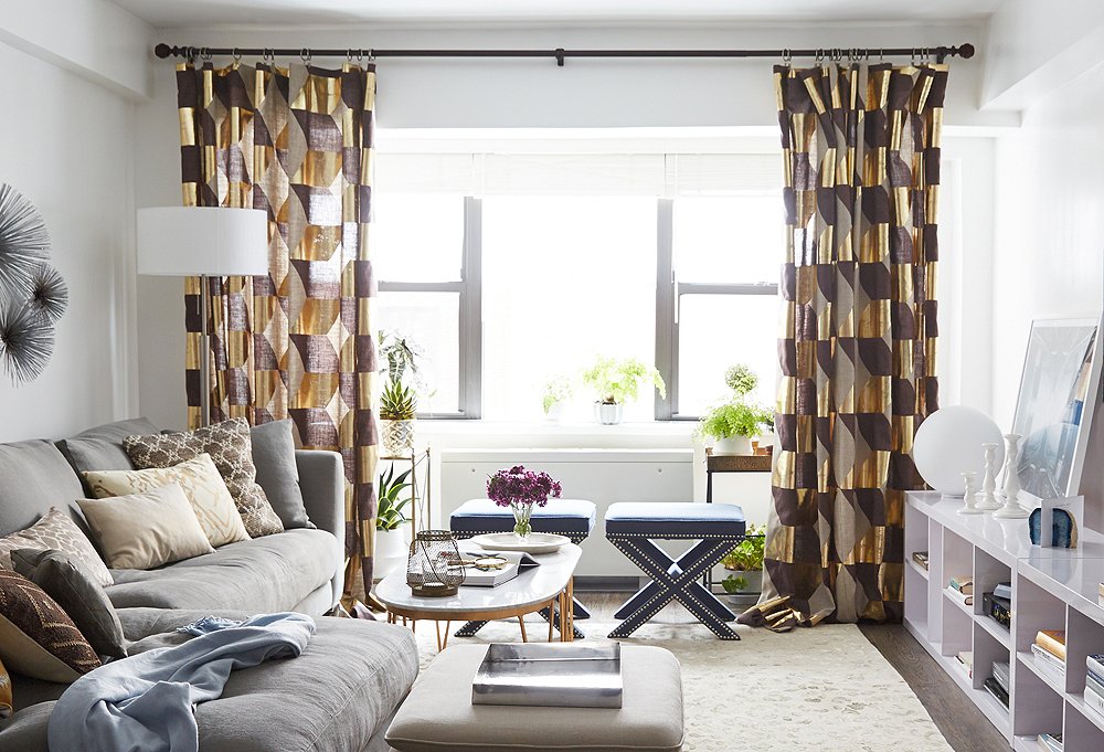 Look how tall the ceilings in this petite living room look thanks to the high-hanging curtains.
