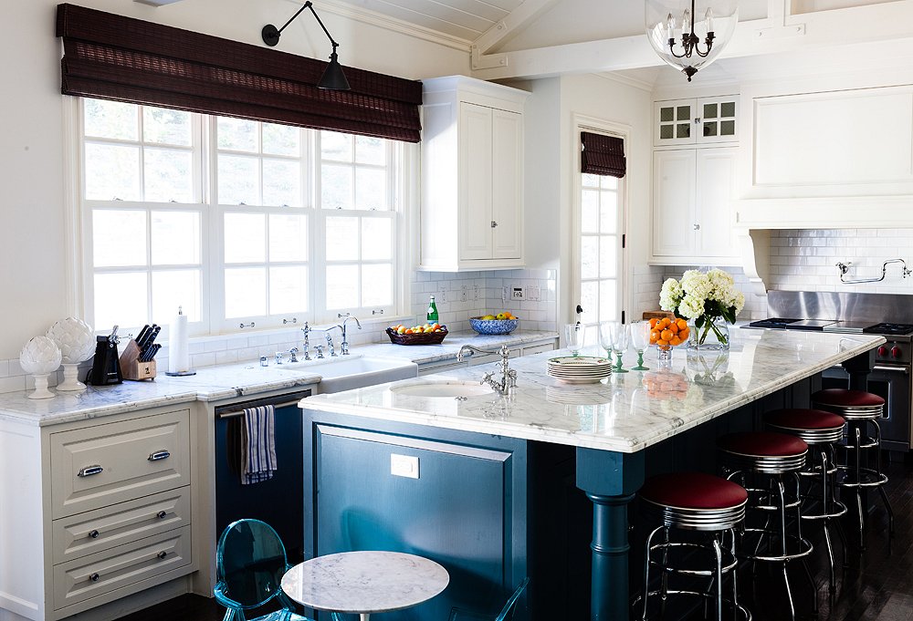 A deep-blue island, which might make another room appear too dark, works in this light-filled kitchen.
