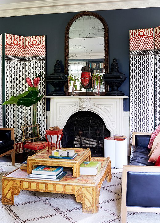 This corner of the library holds more Zajac and Callahan finds: a pair of lively wood panels on either side of the marble fireplace and a double-stacked coffee table that gives the designers even more surface area for their enviable book collection.
