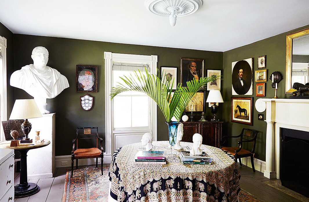 A deep green hue lends depth to a small dining room in artist Frank Faulkner’s upstate New York home. Photo by Pernille Loof.
