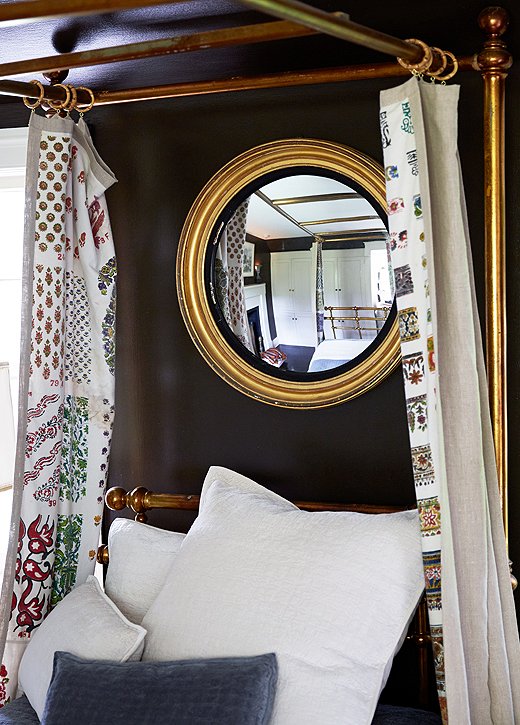 When open the curtains frame a 19th-century gold bull’s-eye mirror; when closed they show their pattern only to the resident of the bed. “I love the element of surprise,” Ross says.
