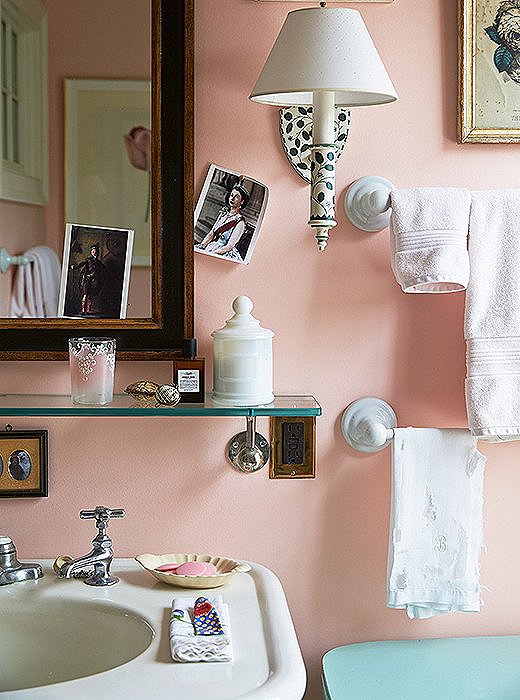 Wanting the ladies’ guest bath to feel romantic and pretty, Jeffrey painted it peach sorbet. The walls pull double-duty as a gallery for an ever-changing rotation of pictures and postcards.
