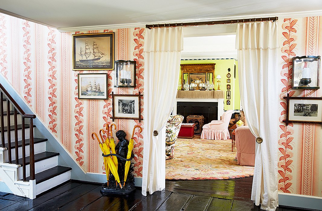 The hallway leading into the living room is papered with a design by Quadrille, a historical reissue called Climbing Hydrangea that first appeared in a scene in Gone with the Wind.
