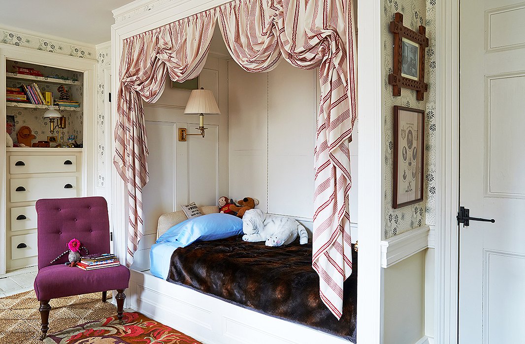 Son Christoph gets a bedroom fit for a prince, or maybe a president—the bed was modeled after one in Thomas Jefferson’s Monticello bedroom. Bustled red-and-white dimity cloth gives the nook an all-American feel while creating a kid-friendly zone perfect for imaginary adventures.
