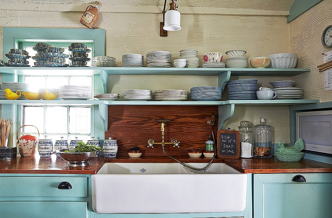 Above the Shaws farm sink and antique brass fixtures sits a portion of Jeffrey’s immense tabletop collection, both complete and partial sets of mostly ironstone china. “I have a vast trove for entertaining, which is always being added to,” he says.

