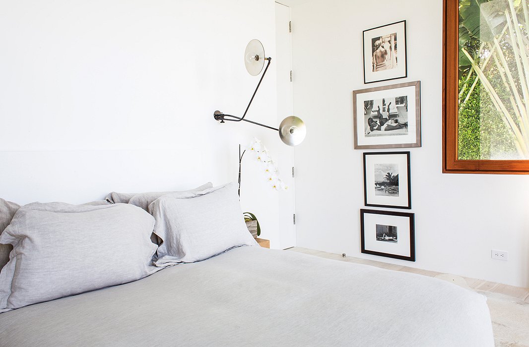 The minimalist sconces are from Workstead. “I prefer sconces to lamps because they disappear,” says Kelly. “They make less of a statement in the room, and they don’t take up space on a side table where you already have your iPad and phone and computer.”
