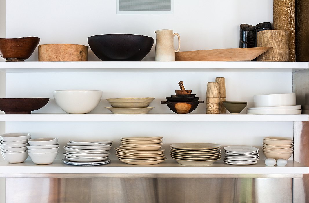 The house’s airiness extends into the kitchen, where open shelving holds Kelly’s collection of dishes and serveware, all in the same low-key palette and natural materials as the rest of the home.
