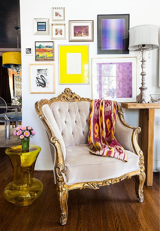 The purple chair’s lavender twin was tucked into another corner of Kim’s living room, under a salon-style art wall that she arranged by first laying the pieces—a mix of flea-market finds and works by friends—on the floor to find the right layout.

