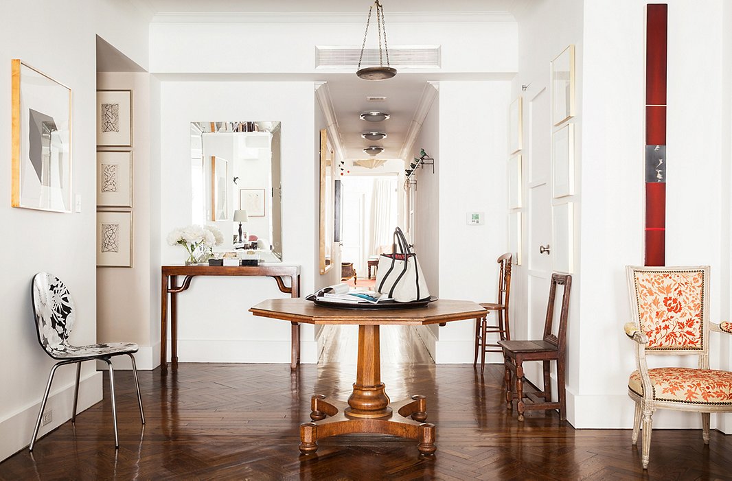 Most of the apartment’s floors are bare, which highlights the shapes of Mariette’s beloved chairs and helps the space feel open by allowing the eye to travel uninterrupted.
