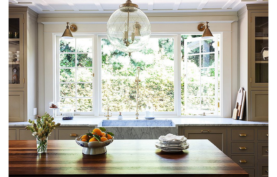 Though the kitchen is new, Megan referenced the original woodwork on the ceilings and brought in traditional touches, from the old-fashioned cabinetry to the island built to look like a French chopping block, complete with brass corner straps.
