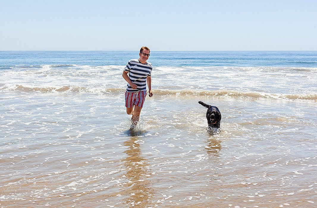 Nathan and his dog, Nacho, who he describes as a “beach bum,” testing out the water after lunch.
