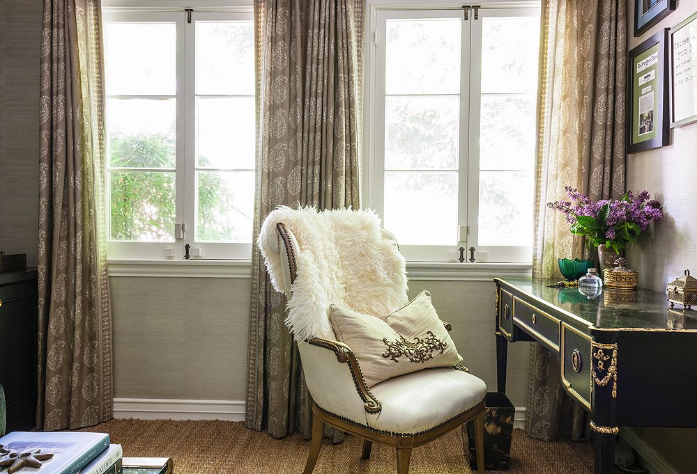 Who says office furniture must be “office furniture”? In Susan’s space, a vintage chair tucks into a vintage desk under a wall hung with a handful of memorable press clippings about One Kings Lane. And the curtains? Made from one of her favorite Peter Dunham fabrics.
