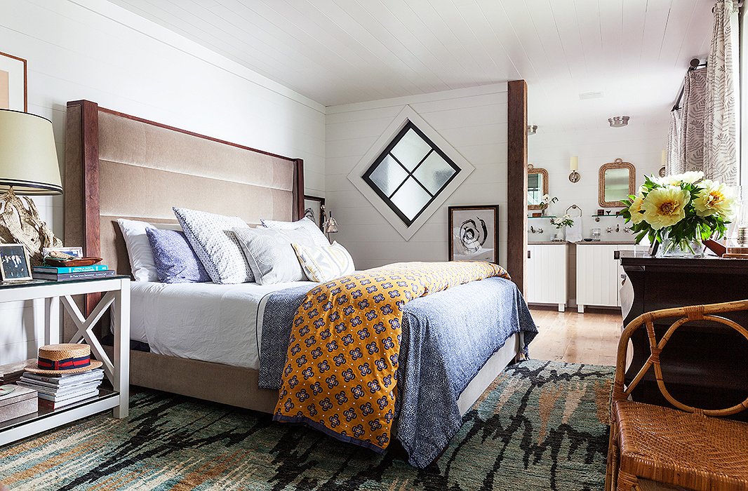 An orange duvet adds an unexpected pop of color and a slightly exotic feel to the master bedroom.

