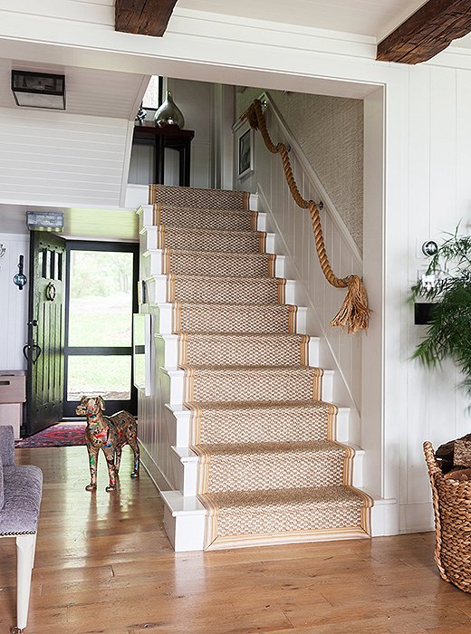 Thom removed the banister to make the entryway feel more open. The rope hung in its place adds whimsy and rugged texture.
