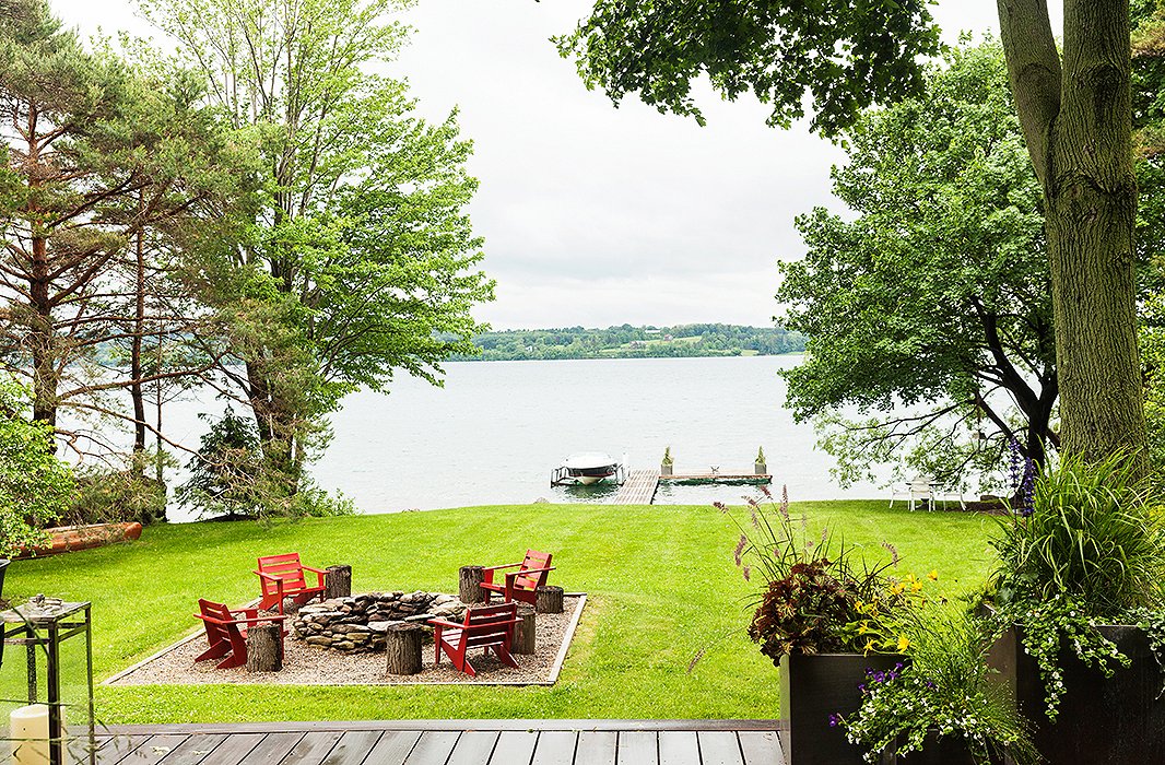 A fire pit overlooks the lake and the dock leading to Thom’s beloved vintage-style Chris Craft motorboat, which he uses to visit friends around the lake.

