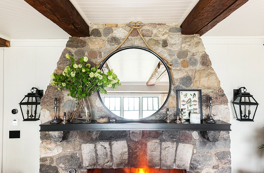 Nautical hardware and rope make the dramatically oversize modern mirror above the fireplace feel natural in a lakeside home.
