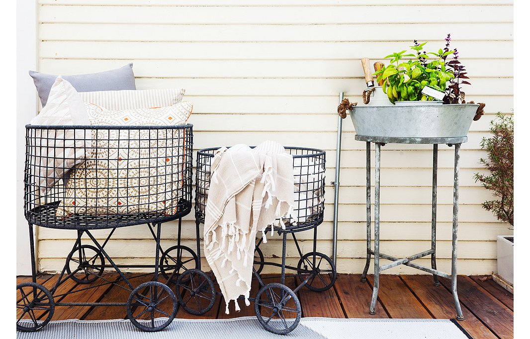 These laundry baskets are used to hold pillows and throws so that guests can get comfortable on the porch.
