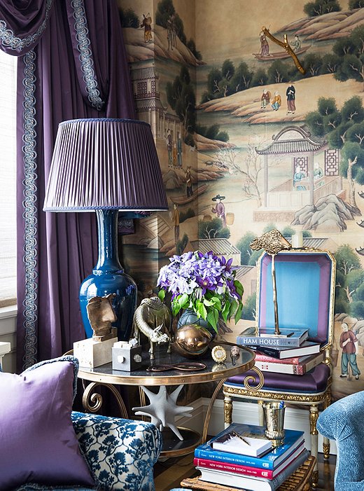 A gilded table that belonged to the designer’s mother houses a collection of treasured objets. The inky-blue glazed lamp was created by Alex for Christopher Spitzmiller.
