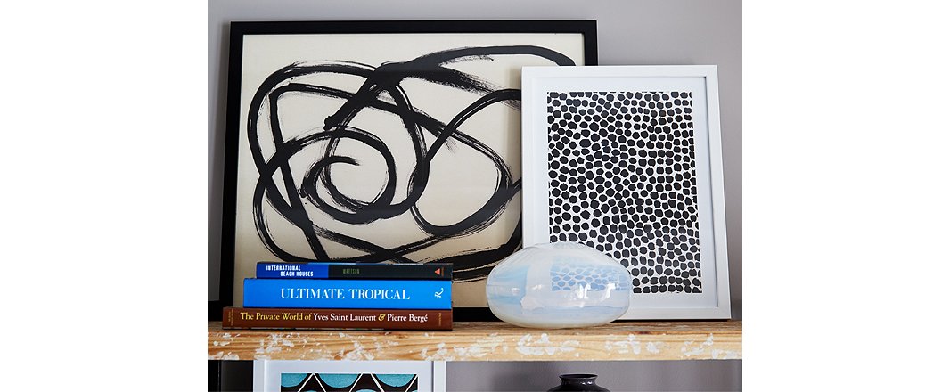 Framed art and photographs leaned against the wall make for a casually stylish shelfscape.
