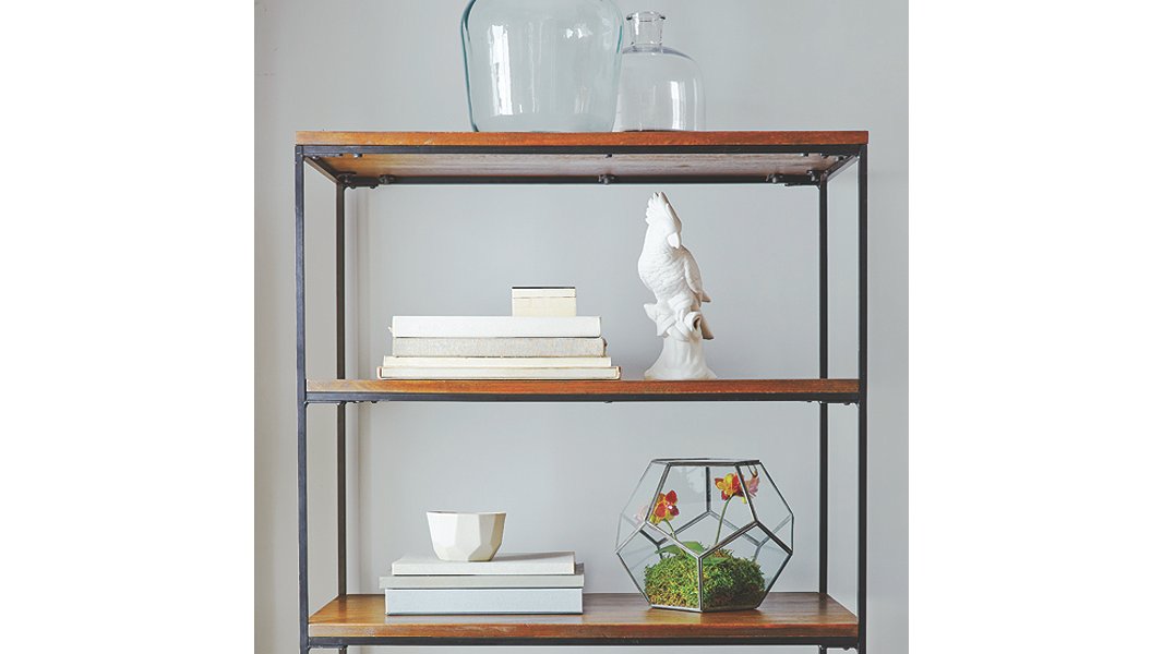 Shelves don’t always have to be crammed full of stuff—letting items “breathe” can help make your room feel airy and spacious.
