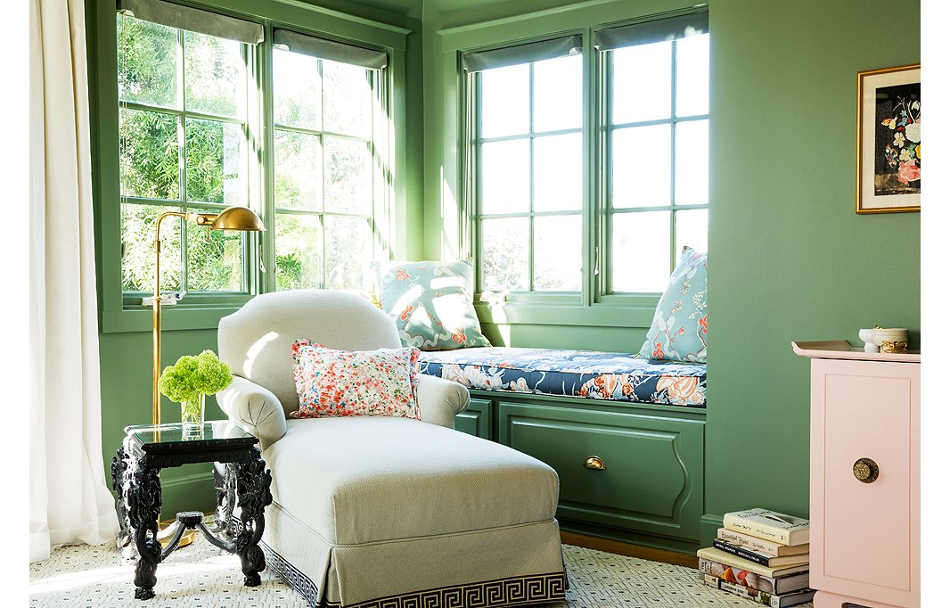 A chaise, a table, and a lamp transform a corner of a bedroom into a cozy library. The window seat is a lovely bonus. Photo by Aubrie Pick; design by Chloe Warner.
