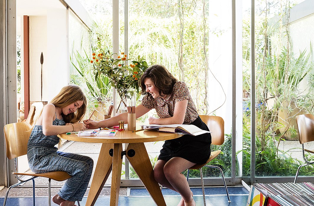 The Prouvé-style dining table doubles as a work space for daughters Madelyn and Kate, who lay out their homework, as well as David for when he’s going over furniture plans after everyone else has gone to bed.   
