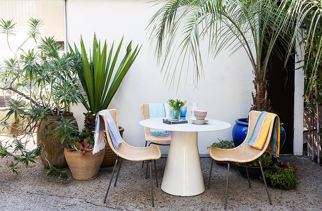 The interior courtyard serves not only as the family’s living room but also as a dining room thanks to a recently added round table tucked away in a garden nook planted with towering lush greenery.
