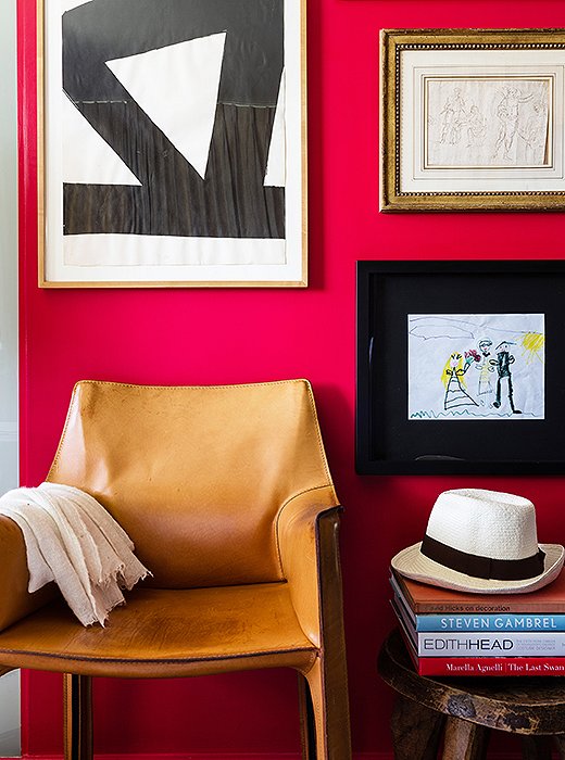 A bold red wall in the master bedroom features a range of favorite art pieces, from a 1970s gouache by Al Held to a 17th-century drawing from David’s parents to a drawing by one of his daughters that was an anniversary gift.
